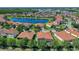 Aerial view of a single-Gathering home with a tile roof, surrounded by a lush landscape and a scenic lake view at 2721 Swoop Cir, Kissimmee, FL 34741