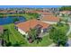 Stunning aerial view of a single-story home highlighting the tile roof and backyard lake at 2721 Swoop Cir, Kissimmee, FL 34741