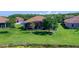 Lush backyard featuring a screened patio, surrounded by green grass and mature trees at 2721 Swoop Cir, Kissimmee, FL 34741