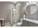 This bathroom features gray vanity with marble top, modern fixtures, and a glass-enclosed shower at 2721 Swoop Cir, Kissimmee, FL 34741