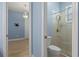 Open doorway to bedroom with a view of a bathroom featuring a glass-enclosed shower and toilet at 2721 Swoop Cir, Kissimmee, FL 34741