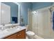 Modern bathroom with wood vanity, clear glass shower, toilet, and brushed nickel accents at 2721 Swoop Cir, Kissimmee, FL 34741