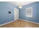 This bright empty bedroom with light blue walls features a double door closet and light toned flooring at 2721 Swoop Cir, Kissimmee, FL 34741