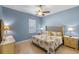 Relaxing bedroom with wooden bed frame, palm-printed bedding, side tables, and light-toned flooring at 2721 Swoop Cir, Kissimmee, FL 34741