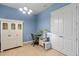 A versatile bedroom space featuring a built-in desk and storage with blue accent wall and ample closet space at 2721 Swoop Cir, Kissimmee, FL 34741