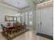 Formal dining room featuring an elegant chandelier, a large table, and white plantation shutters at 2721 Swoop Cir, Kissimmee, FL 34741