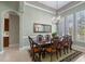 Formal dining room equipped with an elegant chandelier and a large table near the kitchen entry at 2721 Swoop Cir, Kissimmee, FL 34741