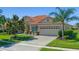 Lovely single-story home showing a well-manicured lawn and a decorative palm tree in the yard at 2721 Swoop Cir, Kissimmee, FL 34741