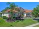 Attractive single-story home displaying colorful landscaping and a healthy palm tree at 2721 Swoop Cir, Kissimmee, FL 34741