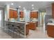 Spacious kitchen features a center island, breakfast bar, stainless hood, and sleek backsplash at 2721 Swoop Cir, Kissimmee, FL 34741