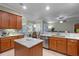 Stylish kitchen featuring granite countertops, modern appliances, custom cabinets, and an island at 2721 Swoop Cir, Kissimmee, FL 34741