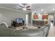 Open floor plan featuring bar seating, kitchen with wood cabinets, and Gathering room with tile floors at 2721 Swoop Cir, Kissimmee, FL 34741