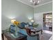 Elegant living room featuring stylish furniture, chandelier, and sliding glass doors to outdoor living space at 2721 Swoop Cir, Kissimmee, FL 34741