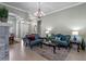 Bright living room featuring tile floors, neutral walls, a chandelier, and stylish seating area at 2721 Swoop Cir, Kissimmee, FL 34741