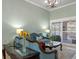 Elegant living room featuring stylish furniture, chandelier, and sliding glass doors to outdoor living space at 2721 Swoop Cir, Kissimmee, FL 34741