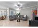 Living room showing gray sectional, view of dining area, and tile flooring at 2721 Swoop Cir, Kissimmee, FL 34741