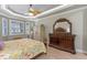 View of main bedroom showing decorative furniture, wood-look floors, and bright windows at 2721 Swoop Cir, Kissimmee, FL 34741