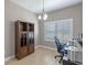 This home office includes a modern desk, chair, and bookshelf, as well as light-toned flooring at 2721 Swoop Cir, Kissimmee, FL 34741