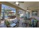 Inviting covered patio featuring comfortable seating, ceiling fans, and views of the peaceful water setting at 2721 Swoop Cir, Kissimmee, FL 34741