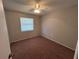 Simple bedroom with carpet flooring, neutral walls, and a window providing natural light at 2813 Calico Ct, Orlando, FL 32822