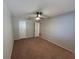 This bedroom has neutral walls, carpet, and two entry doors with a ceiling fan for comfortable living at 2813 Calico Ct, Orlando, FL 32822