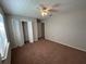 This bedroom has neutral walls, carpet, and closet space with a ceiling fan for comfortable living at 2813 Calico Ct, Orlando, FL 32822