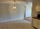 Bright dining area with tile flooring, modern light fixture, and neutral wall paint at 2813 Calico Ct, Orlando, FL 32822