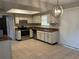 Functional kitchen with white cabinetry, stainless steel appliances, and a tile floor at 2813 Calico Ct, Orlando, FL 32822