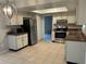 Well-lit kitchen featuring white cabinets, stainless steel appliances, and tile flooring at 2813 Calico Ct, Orlando, FL 32822