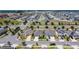 An elevated view of a well-maintained residential neighborhood showcases orderly streets, verdant landscaping, and houses with solar panels at 308 Buchannan Dr, Davenport, FL 33837
