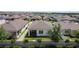 A high angle shows the backyard and screened lanai within a fenced yard at 308 Buchannan Dr, Davenport, FL 33837
