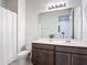 Well-lit bathroom featuring a large mirror, a single vanity, and a shower with tub at 308 Buchannan Dr, Davenport, FL 33837