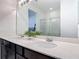 Bathroom features a double vanity with quartz countertops, dark wood cabinets, and modern fixtures at 308 Buchannan Dr, Davenport, FL 33837
