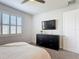 Comfortable bedroom with a dresser and mounted television, creating a relaxing retreat at 308 Buchannan Dr, Davenport, FL 33837