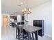View of the dining room featuring a chandelier, a table, and an open view of the kitchen at 308 Buchannan Dr, Davenport, FL 33837