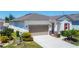 The attractive home includes a two car garage and a beautifully landscaped yard at 308 Buchannan Dr, Davenport, FL 33837