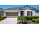 Inviting single-story home with a well-maintained lawn and neutral color palette at 308 Buchannan Dr, Davenport, FL 33837