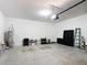 Uncluttered garage with concrete flooring, automatic door opener, and a hot water heater at 308 Buchannan Dr, Davenport, FL 33837