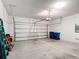 Spacious garage with an automatic door opener, concrete floors, and ample storage space at 308 Buchannan Dr, Davenport, FL 33837