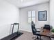 Functional home office with a modern desk setup and fitness equipment, promoting productivity at 308 Buchannan Dr, Davenport, FL 33837