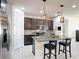 Modern kitchen with a spacious island, dark cabinets, and stainless steel appliances at 308 Buchannan Dr, Davenport, FL 33837