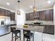 Kitchen island featuring granite countertops, pendant lighting, and dark wood cabinetry at 308 Buchannan Dr, Davenport, FL 33837