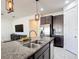 Modern kitchen island featuring granite countertops, stainless steel appliances, and pendant lighting at 308 Buchannan Dr, Davenport, FL 33837