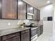 Well-equipped kitchen featuring stainless steel appliances, gray subway tile backsplash, and granite countertops at 308 Buchannan Dr, Davenport, FL 33837