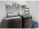 Laundry room featuring a gray washer and dryer with a shelf overhead for storage at 308 Buchannan Dr, Davenport, FL 33837