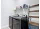Modern laundry room featuring a gray washer and dryer set with a white shelf above at 308 Buchannan Dr, Davenport, FL 33837