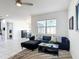 Living room with a comfortable sofa, bright window, and an open view to the dining area at 308 Buchannan Dr, Davenport, FL 33837