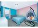 Colorful bedroom featuring an ombre wall, a hanging chair and carpet flooring at 3134 Viceroy Ct, Poinciana, FL 34759