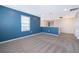 Large bonus room featuring carpeted floors, blue walls, and natural light at 3134 Viceroy Ct, Poinciana, FL 34759