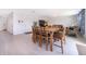 Bright dining room area with wood table and seating and neutral tile flooring at 3134 Viceroy Ct, Poinciana, FL 34759